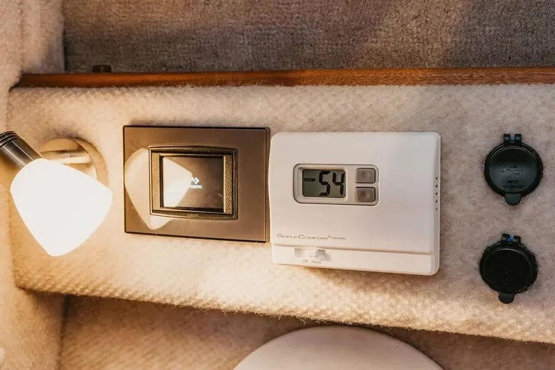 Slide: The Image of Interior of 2026 KingFisher 38 GFX boat with thermostat and light fixture. - 5