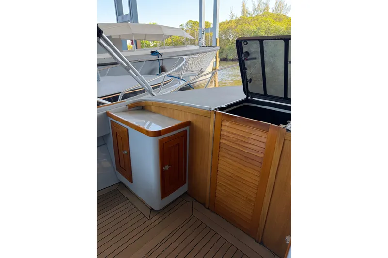 Slide: The Image of 2024 Strike 29 FT Center Console with cuddy, featuring sleek wooden cabinetry and open hatch. - 13
