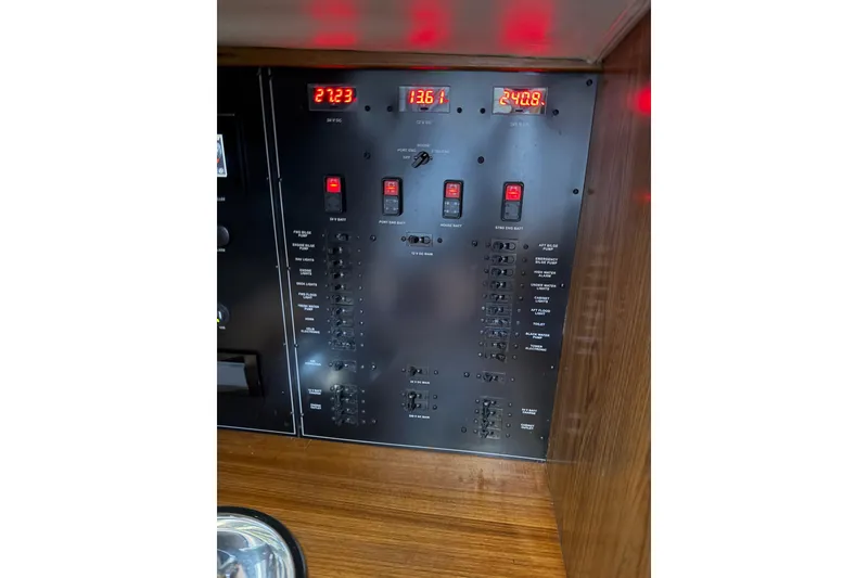 Slide: The Image of Electrical panel of 2024 Strike 29 FT Center Console with Cuddy, featuring digital displays and switches. - 15