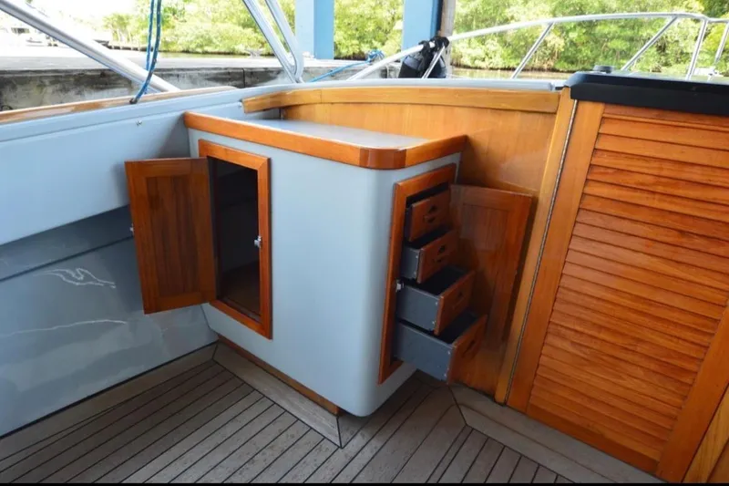 Slide: The Image of 2024 Strike 29 FT Center Console with cuddy, featuring wooden cabinetry and drawers. - 2