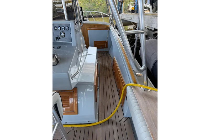 Slide: The Image of 2024 Strike 29 FT Center Console with Cuddy, featuring teak deck and cushioned seating. - 25