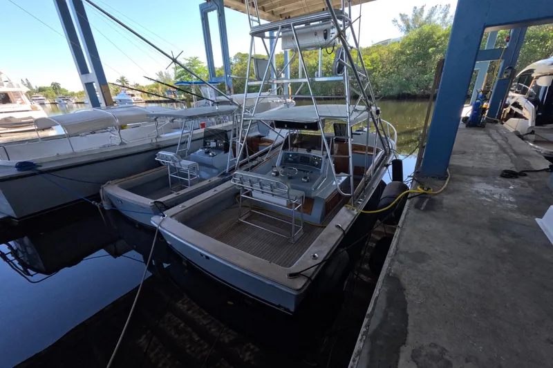 Slide: The Image of 2024 Strike 29 FT Center Console with cuddy, docked, showcasing sleek design and spacious layout. - 35