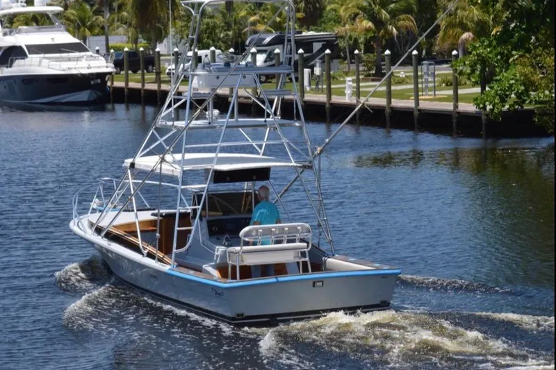 Slide: The Image of 2024 Strike 29' Center Console boat with cuddy, cruising on a serene river. - 49