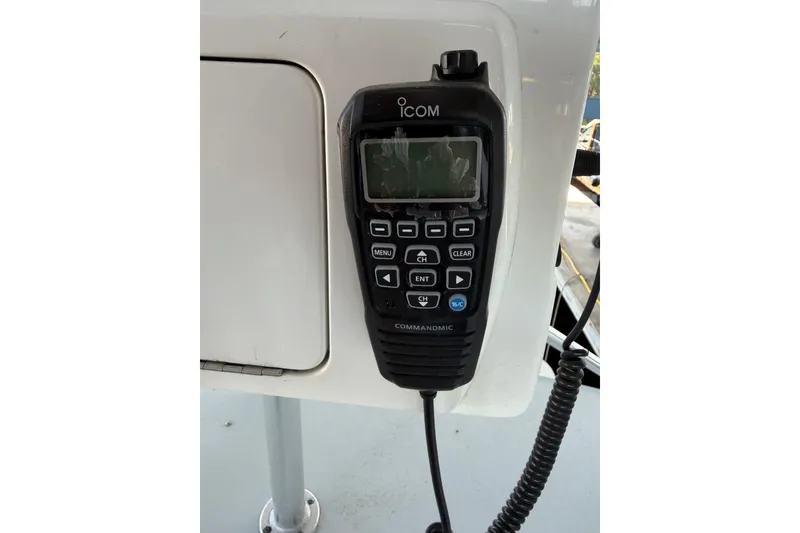 Slide: The Image of Icom CommandMic on 2024 Strike 29 FT Center Console boat, mounted on white panel. - 10