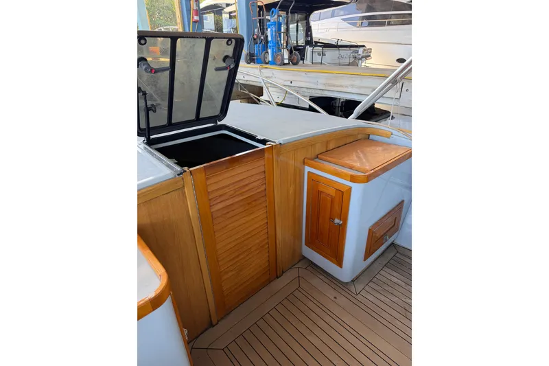 Slide: The Image of 2024 Strike 29 FT Center Console with cuddy, featuring wooden cabinetry and open hatch. - 12