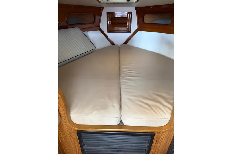 Slide: The Image of 2024 Strike 29 FT Center Console cuddy cabin interior with beige cushions. - 16
