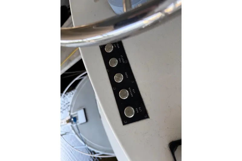 Slide: The Image of 2024 Strike 29 FT Center Console boat dashboard with steering wheel and control panel. - 22