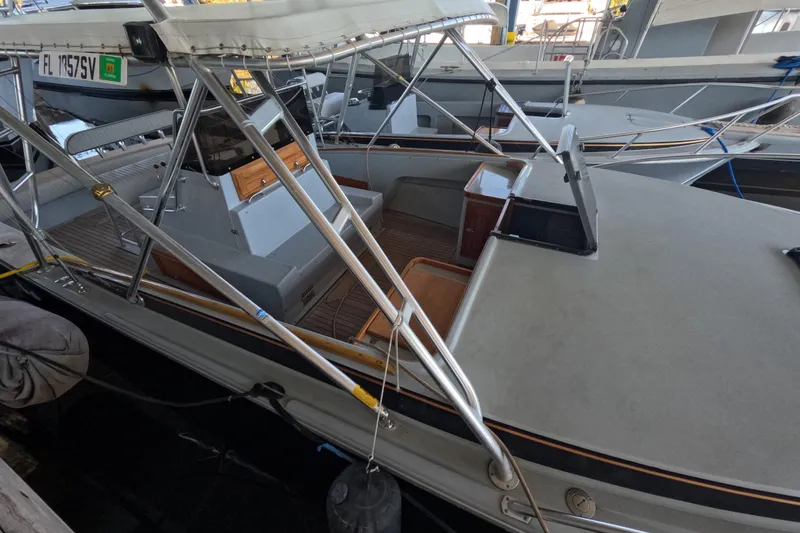 Slide: The Image of 2024 Strike 29 FT Center Console with Cuddy under marina roof, docked near other boats. - 39