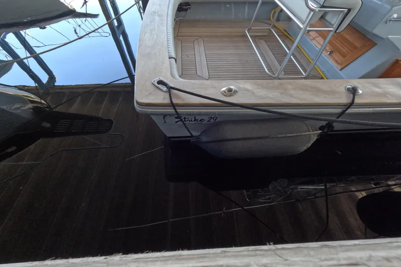 Slide: The Image of 2024 Strike 29 FT Center Console with Cuddy, docked, showing deck and seating area. - 44