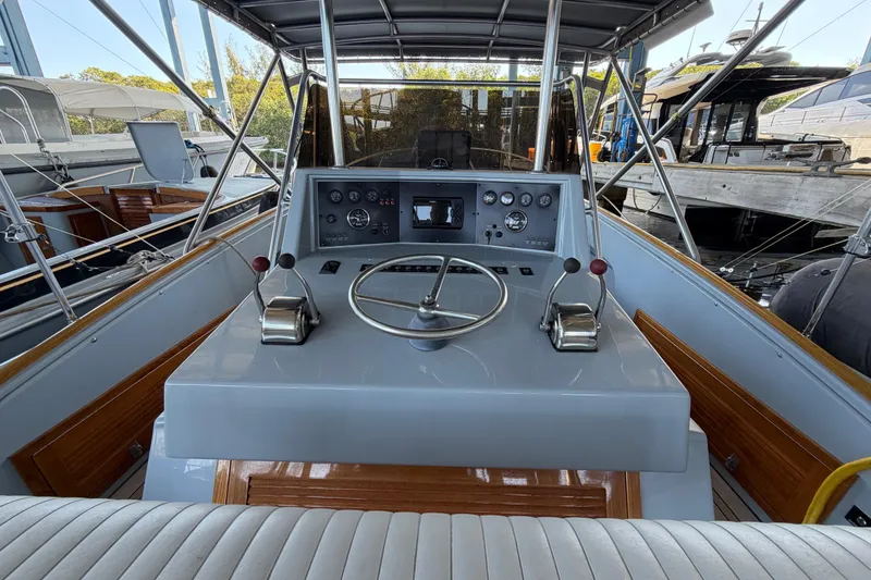 Slide: The Image of 2024 Strike 29 FT Center Console with Cuddy, featuring helm controls and steering wheel. - 5