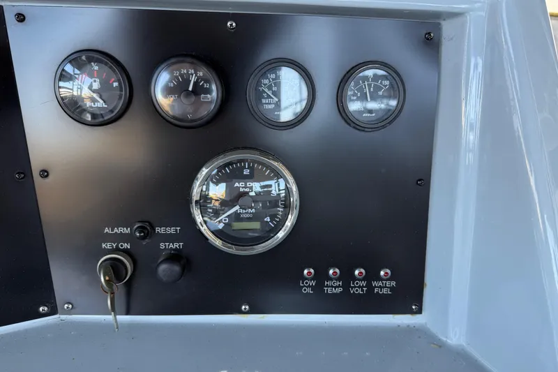 Slide: The Image of 2024 Strike 29 FT Center Console dashboard with gauges and ignition key. - 8