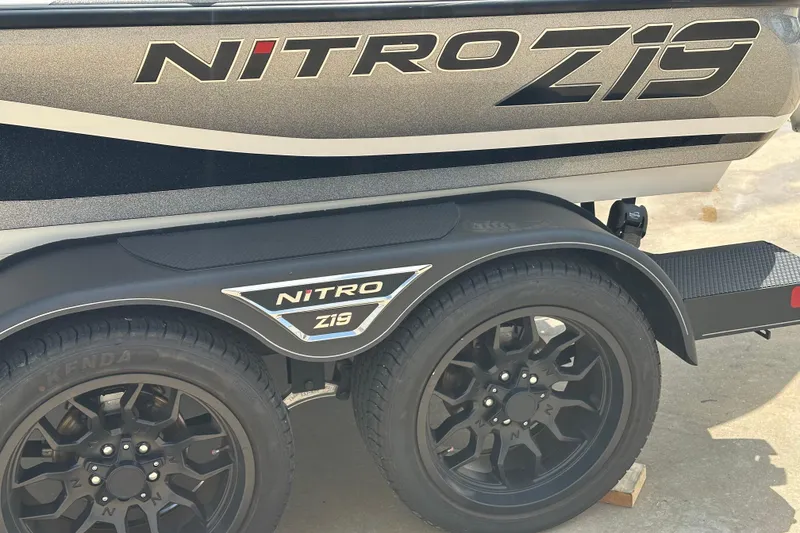 Slide: The Image of 2023 Nitro Z19 boat trailer with black wheels and bold branding. - 11