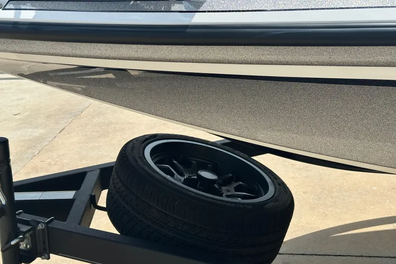 Slide: The Image of 2023 Nitro Z19 boat on trailer with black wheel, close-up view. - 12