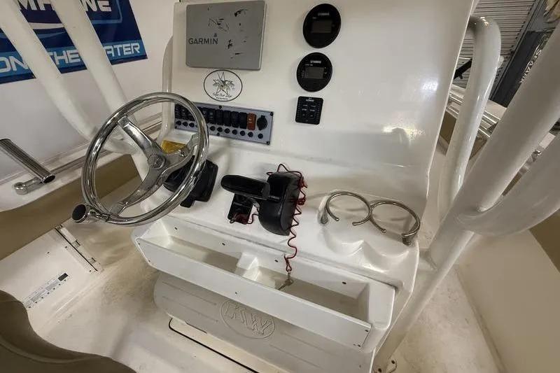 Slide: The Image of 2018 Key West 219 FS boat console with Garmin navigation and steering wheel. - 10