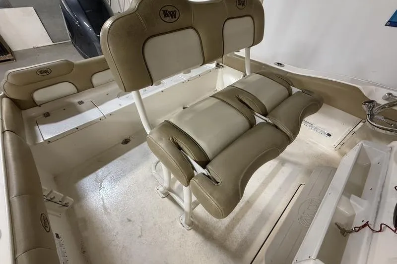 Slide: The Image of 2018 Key West 219 FS boat interior with beige seating and storage compartments. - 12