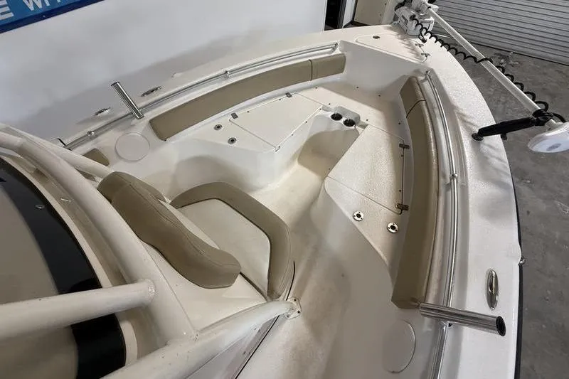 Slide: The Image of 2018 Key West 219 FS boat interior with beige seating and white deck. - 13