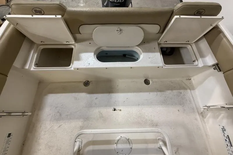 Slide: The Image of 2018 Key West 219 FS boat interior with storage compartments and seating area. - 5