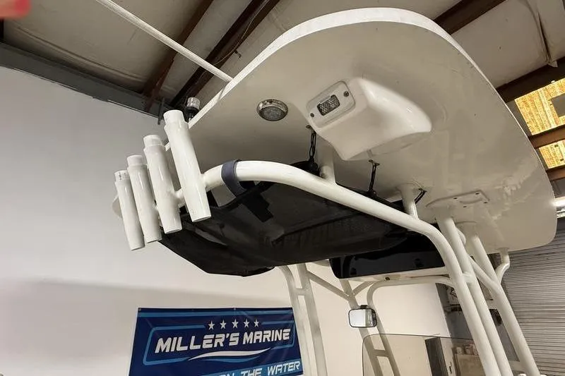 Slide: The Image of 2018 Key West 219 FS boat T-top with rod holders and storage, displayed at Miller's Marine. - 9