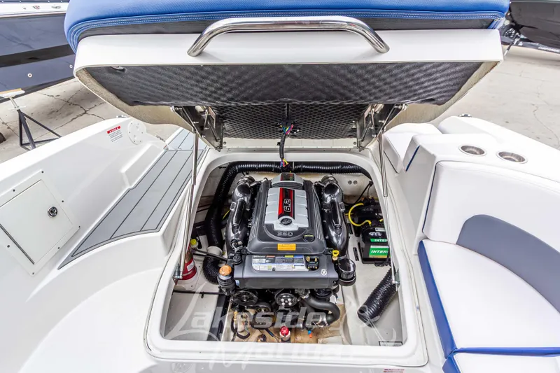 Slide: The Image of Engine compartment of 2021 Chaparral 267 SSX boat, showcasing powerful motor and seating area. - 16
