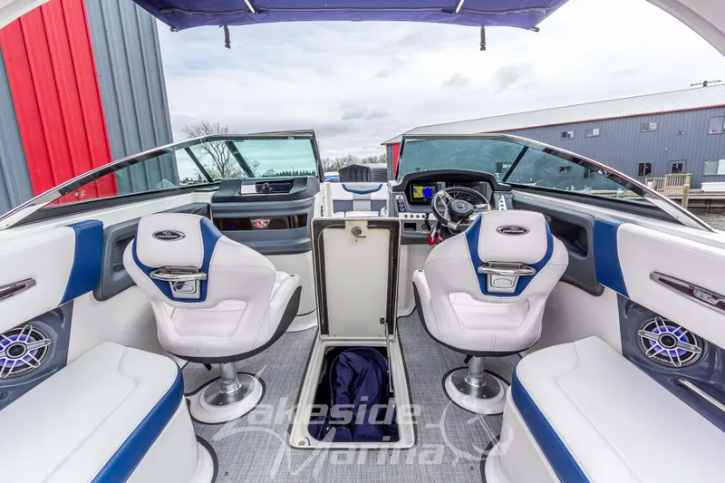 Slide: The Image of 2021 Chaparral 267 SSX boat interior with modern dashboard and seating. - 18