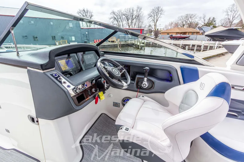 Slide: The Image of 2021 Chaparral 267 SSX boat cockpit with modern dashboard and comfortable seating. - 20