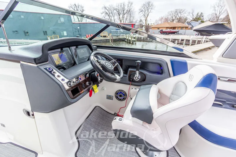 Slide: The Image of Cockpit of 2021 Chaparral 267 SSX boat with modern controls and steering wheel. - 21