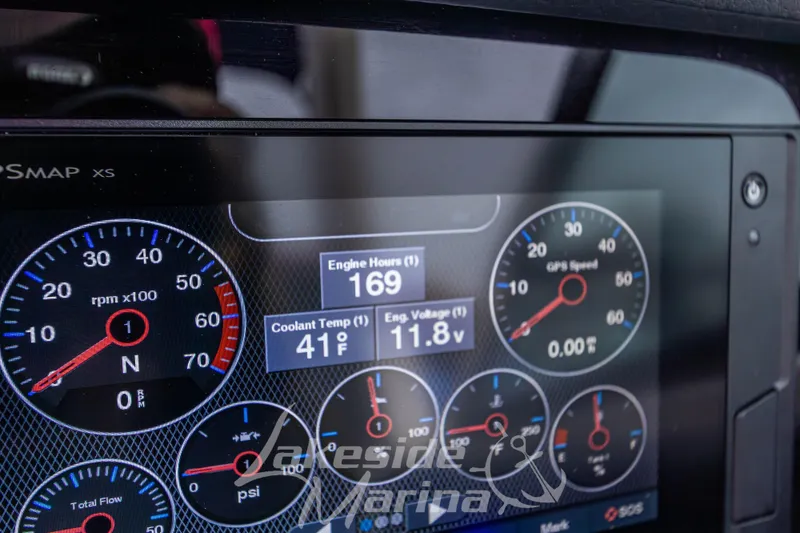 Slide: The Image of Dashboard of 2021 Chaparral 267 SSX showing engine hours, temperature, and voltage. - 23