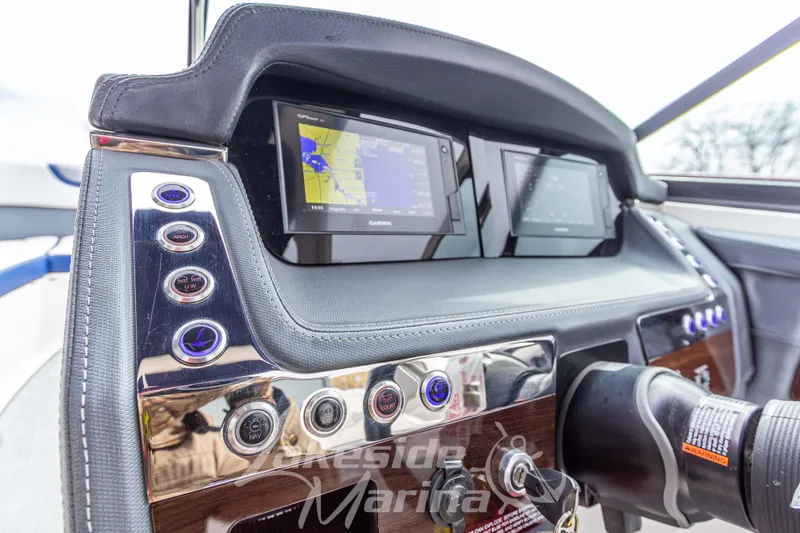 Slide: The Image of Dashboard of 2021 Chaparral 267 SSX boat with navigation screens and control buttons. - 24