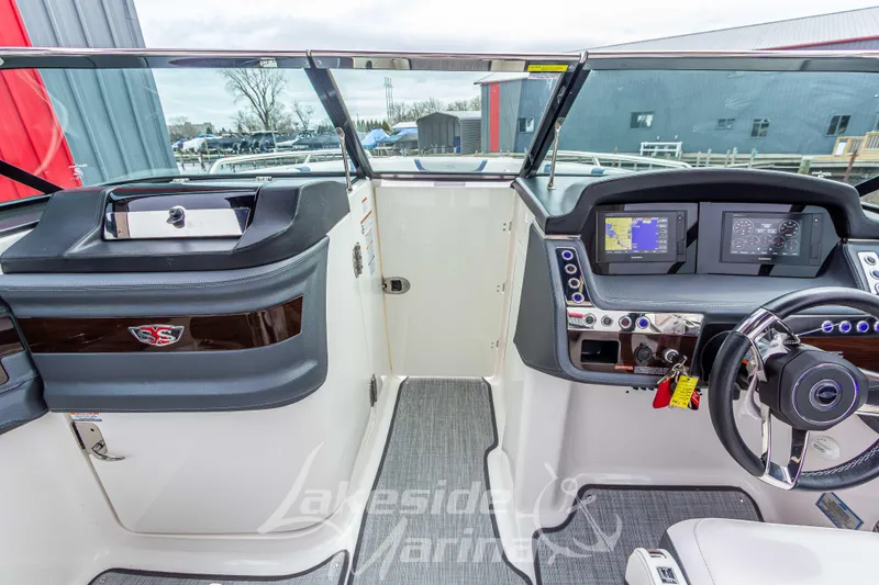 Slide: The Image of 2021 Chaparral 267 SSX boat cockpit with modern dashboard and steering wheel. - 28