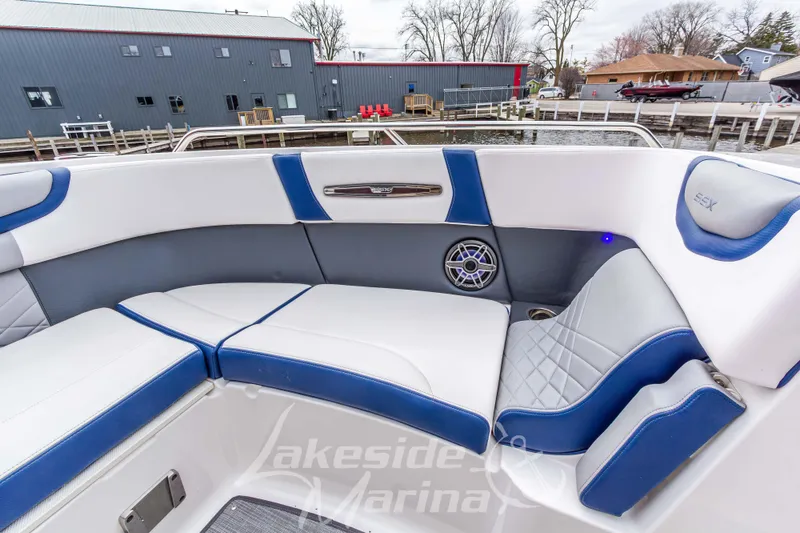 Slide: The Image of 2021 Chaparral 267 SSX boat interior with blue and white seating at Lakeside Marina. - 32