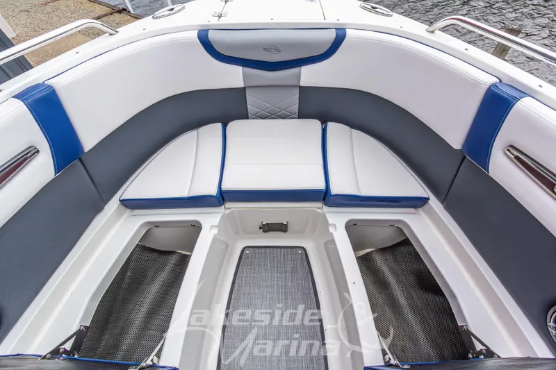 Slide: The Image of 2021 Chaparral 267 SSX boat interior with white and blue seating, storage compartments. - 36