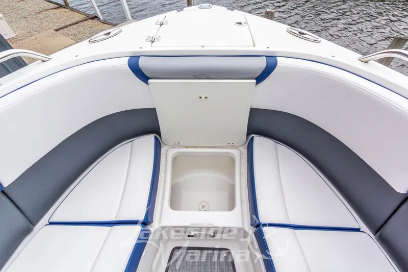 Slide: The Image of 2021 Chaparral 267 SSX boat interior with cushioned seating and storage compartment. - 38