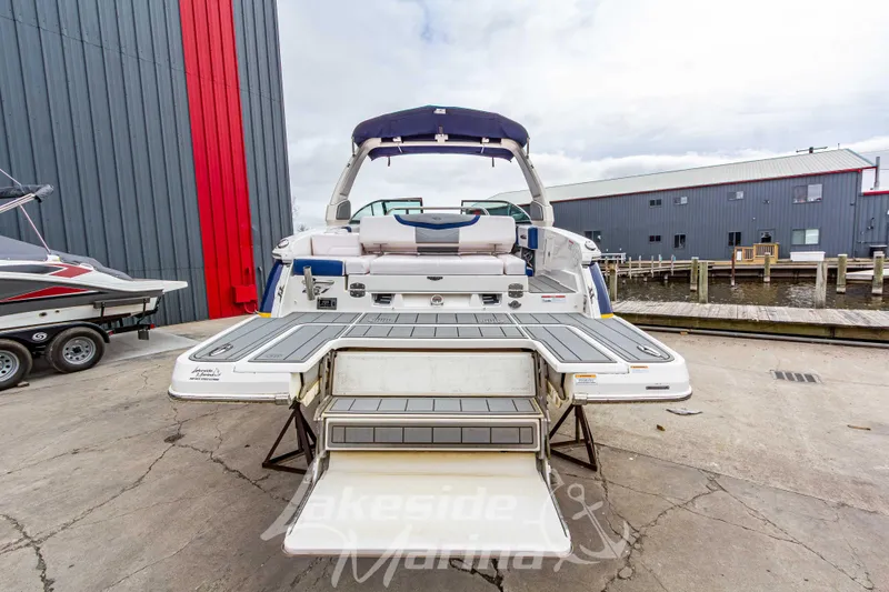 Slide: The Image of 2021 Chaparral 267 SSX boat with extended swim platform at marina dock. - 5