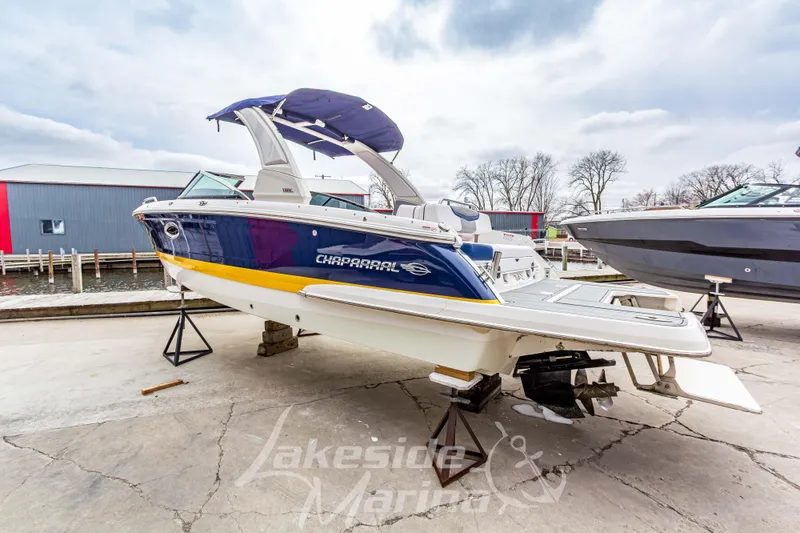 Slide: The Image of 2021 Chaparral 267 SSX boat on display at Lakeside Marina, featuring sleek design and vibrant colors. - 7
