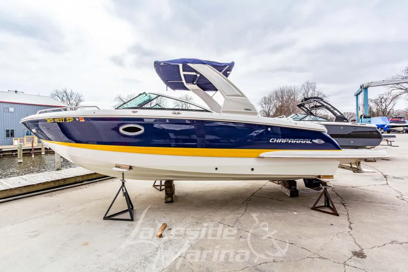 Slide: The Image of 2021 Chaparral 267 SSX boat on display at a marina, featuring sleek design. - 8