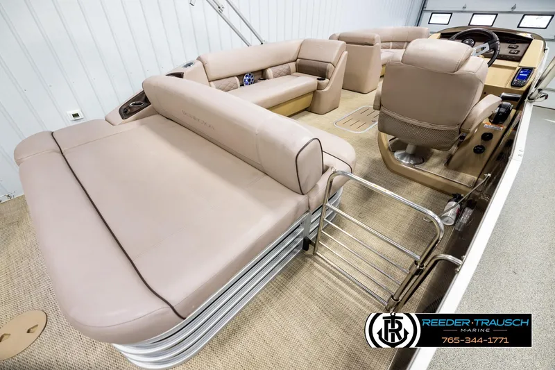 Slide: The Image of 2018 Bennington 24 SSBXPDL pontoon boat interior with beige seating and helm. - 12