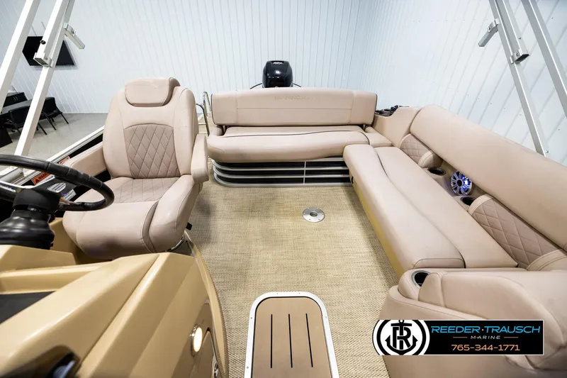 Slide: The Image of 2018 Bennington 24 SSBXPDL pontoon boat interior with beige seating and steering console. - 14