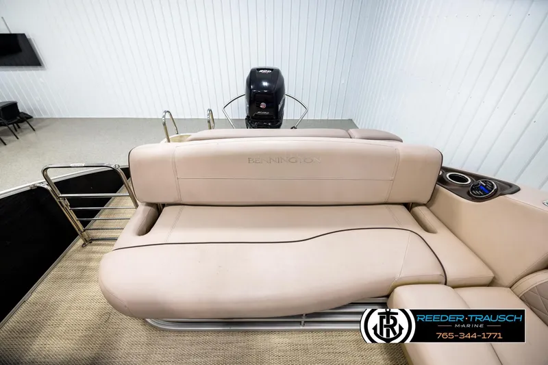 Slide: The Image of 2018 Bennington 24 SSBXPDL pontoon boat interior with beige seating and cup holders. - 15