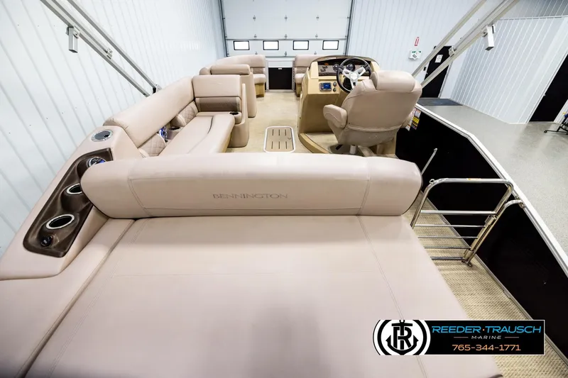 Slide: The Image of 2018 Bennington 24 SSBXPDL pontoon boat interior with beige seating and helm. - 16