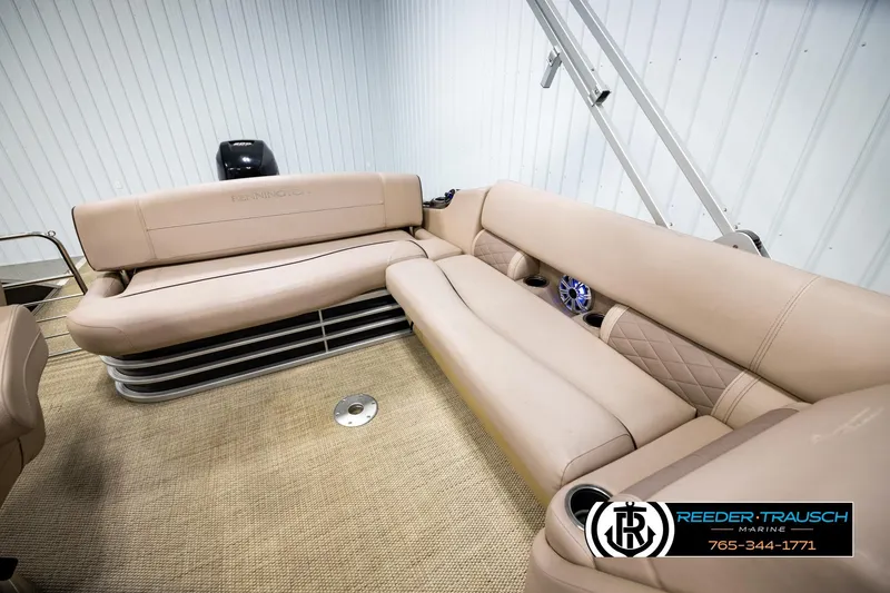 Slide: The Image of 2018 Bennington 24 SSBXPDL pontoon boat interior with beige seating and cup holders. - 22