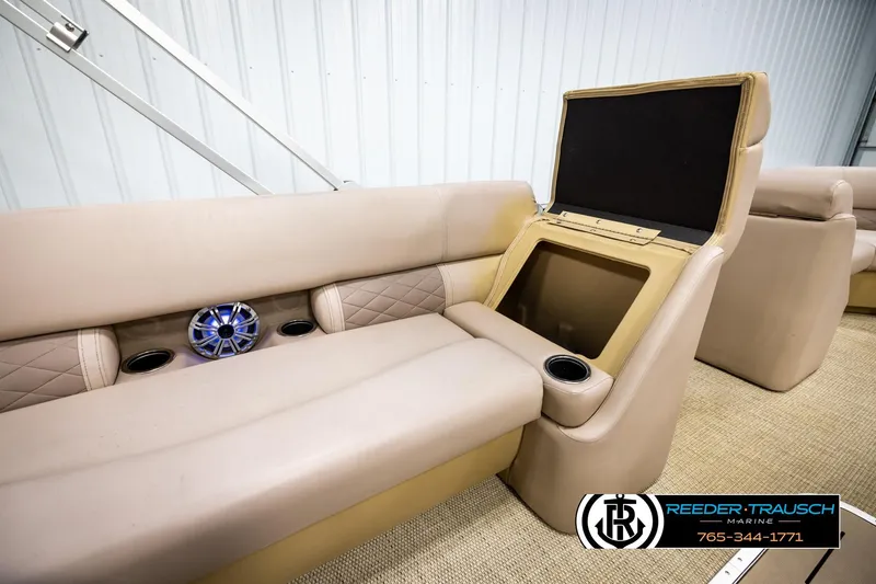 Slide: The Image of 2018 Bennington 24 SSBXPDL boat interior with beige seating and storage compartment. - 26