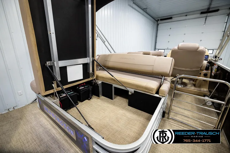 Slide: The Image of 2018 Bennington 24 SSBXPDL pontoon boat interior with beige seating and storage area. - 29