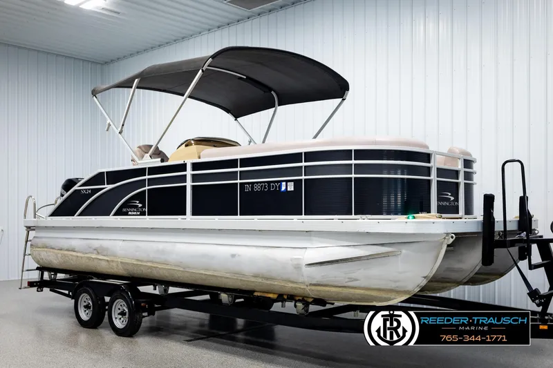 Slide: The Image of 2018 Bennington 24 SSBXPDL pontoon boat on trailer in indoor storage. - 3