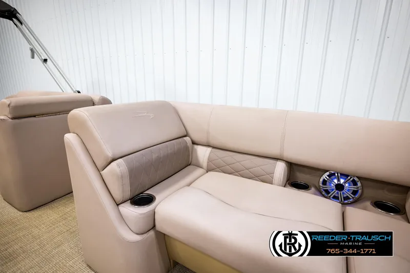 Slide: The Image of 2018 Bennington 24 SSBXPDL boat interior with beige seating and built-in speaker. - 30