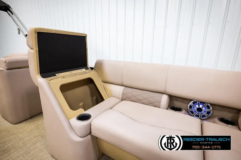 Slide: The Image of 2018 Bennington 24 SSBXPDL boat interior with storage compartment and speaker. - 31