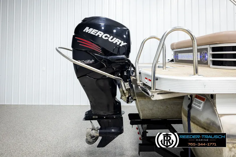 Slide: The Image of 2018 Bennington 24 SSBXPDL pontoon boat with Mercury outboard motor in showroom. - 47