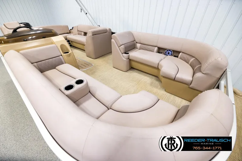 Slide: The Image of 2018 Bennington 24 SSBXPDL pontoon boat interior with beige seating and cup holders. - 9