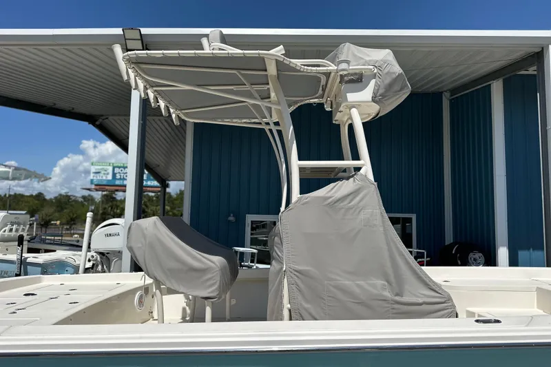 Slide: The Image of 2014 Pathfinder 2600 HPS boat with covered seating and T-top under a metal canopy. - 15