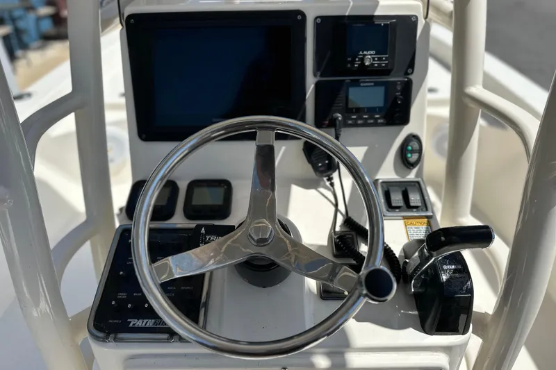 Slide: The Image of Steering console of 2014 Pathfinder 2600 HPS boat with navigation controls. - 16