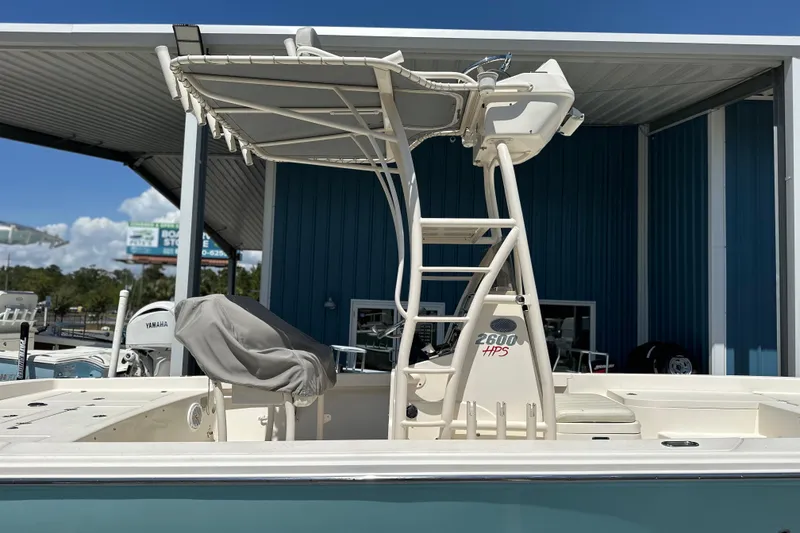 Slide: The Image of 2014 Pathfinder 2600 HPS boat with T-top and Yamaha engine, docked outdoors. - 4